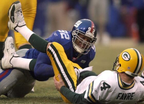 Gastineau congratulates Strahan after breaking the single-season sack record.