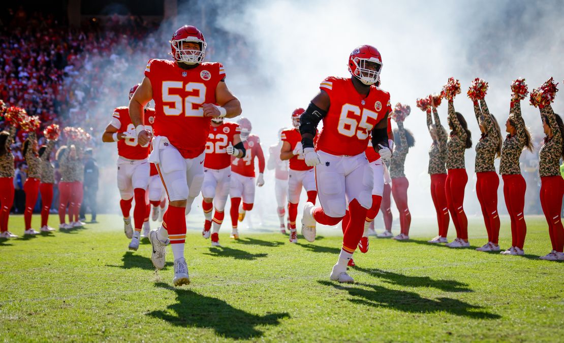 KANSAS CITY, MISSOURI - NOVEMBER 10: Creed Humphrey #52 of the Kansas City Chiefs and Trey Smith #65 of the Kansas City Chiefs run onto the field during player introductions prior to the game against the Denver Broncos at GEHA Field at Arrowhead Stadium on November 10, 2024 in Kansas City, Missouri. (Photo by David Eulitt/Getty Images)