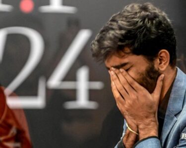 A fan takes a selfie with India's grandmaster Gukesh Dommaraju, center, after his win against China's chess grandmaster Ding Liren in game 14 of the 2024 FIDE World Championship in Singapore on December 12.