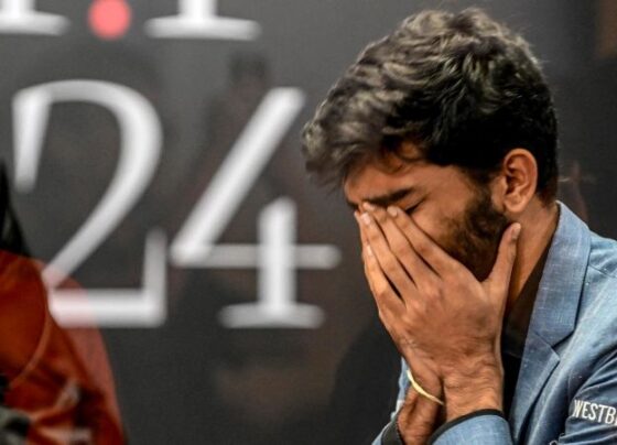 A fan takes a selfie with India's grandmaster Gukesh Dommaraju, center, after his win against China's chess grandmaster Ding Liren in game 14 of the 2024 FIDE World Championship in Singapore on December 12.