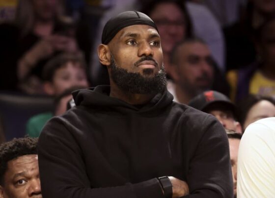 LeBron James and his son, Bronny, look on from the bench during the first half of the Lakers' game against the Portland Trail Blazers at Crypto.com Arena on December 8.