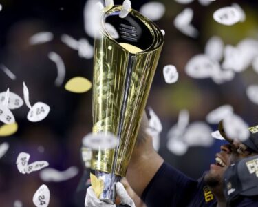 Jordan James of the Oregon Ducks is congratulated by his teammates after scoring a touchdown in the Big Ten Championship on December 7.