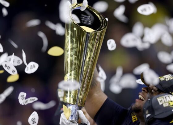 Jordan James of the Oregon Ducks is congratulated by his teammates after scoring a touchdown in the Big Ten Championship on December 7.