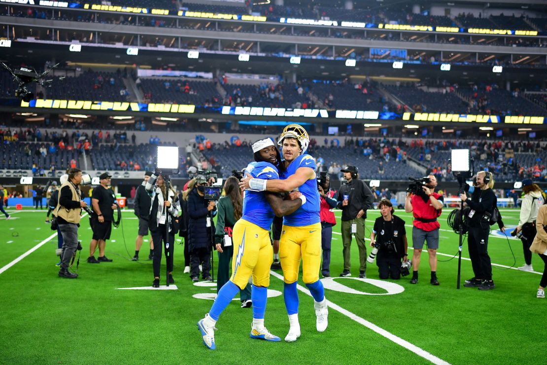 Los Angeles Chargers running back Gus Edwards and quarterback Justin Herbert celebrate after the game.