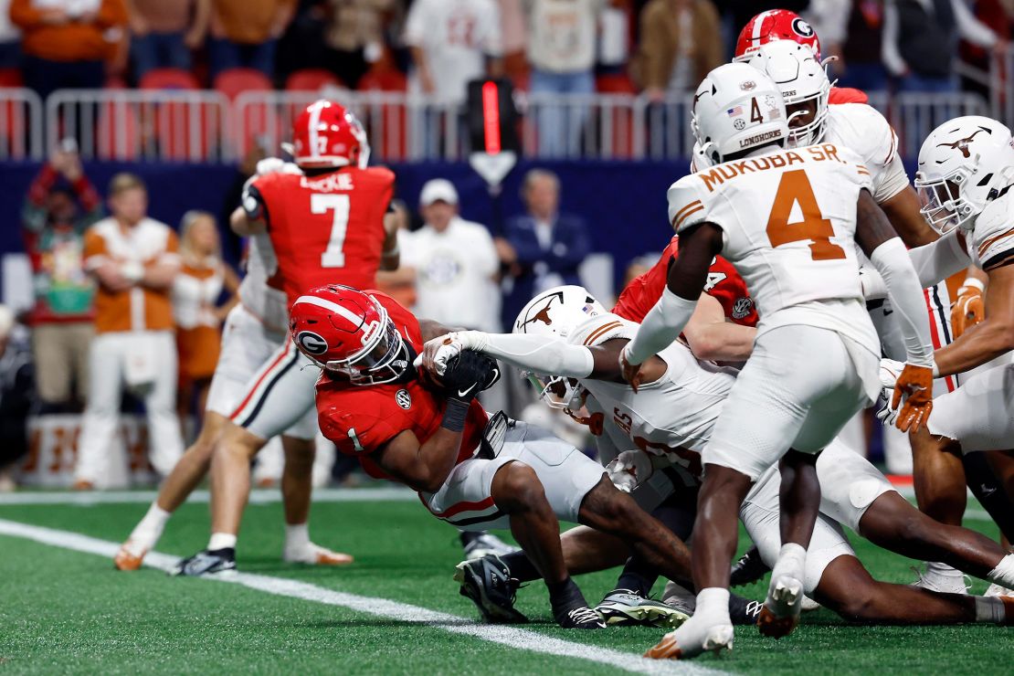 Trevor Etienne of the Georgia Bulldogs scores a touchdown against the Texas Longhorns in overtime to win 22-19 in the 2024 SEC Championship at Mercedes-Benz Stadium on December 7 in Atlanta.