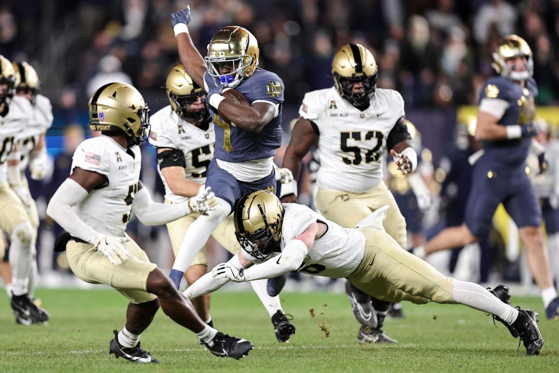 Jeremiyah Love of the Notre Dame Fighting Irish is tackled by Max DiDomenico of the Army Black Knights during the second quarter of the game at Yankee Stadium on November 23 in New York City.