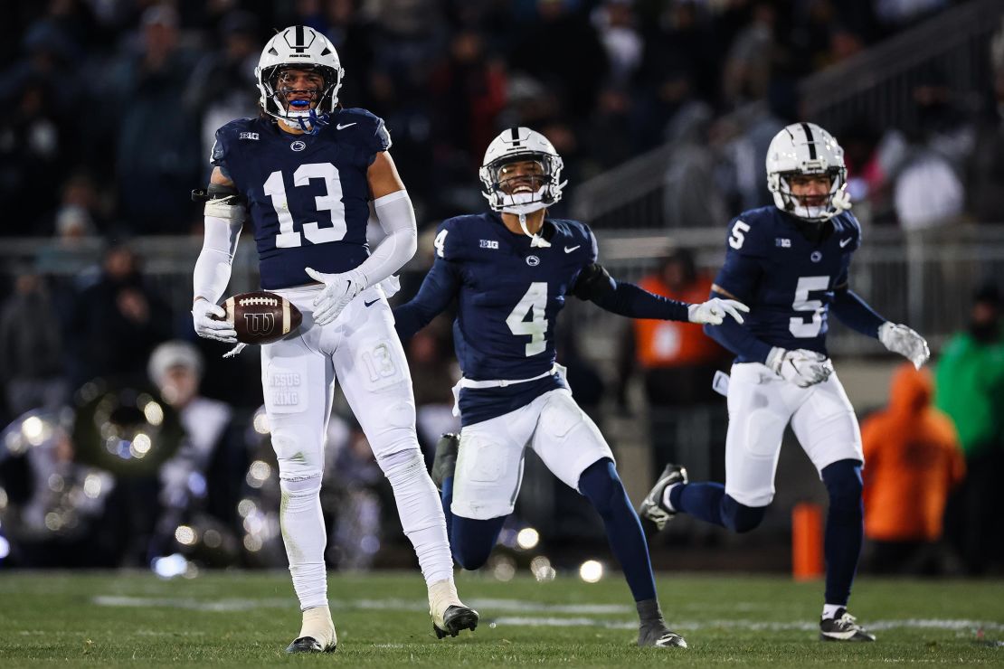 Tony Rojas of the Penn State Nittany Lions celebrates with AJ Harris and Cam Miller after intercepting a pass against Maryland during the first half at Beaver Stadium on November 30 in Happy Valley.