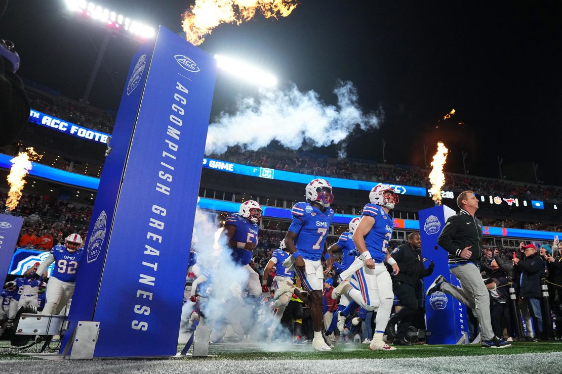 Head coach Rhett Lashlee leads the SMU Mustangs onto the field before the 2024 ACC Football Championship at Bank of America Stadium on December 7, in Charlotte, North Carolina.