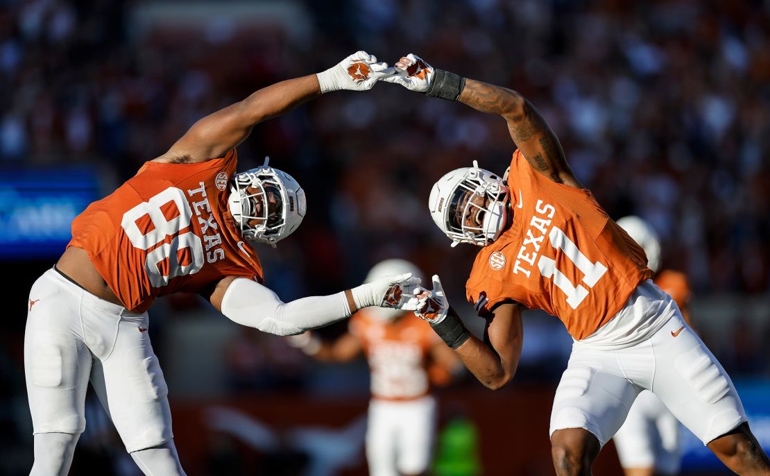 Texas Longhorns duo Barryn Sorrell and Colin Simmons celebrate a sack in the second quarter against the Kentucky Wildcats at Darrell K Royal-Texas Memorial Stadium on November 23 in Austin, Texas.