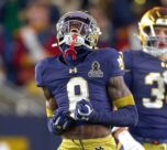 Notre Dame Fighting Irish running back Jeremiyah Love jumps over Indiana Hoosiers defensive back Amare Ferrell.