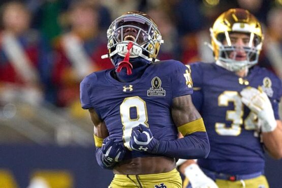 Notre Dame Fighting Irish running back Jeremiyah Love jumps over Indiana Hoosiers defensive back Amare Ferrell.