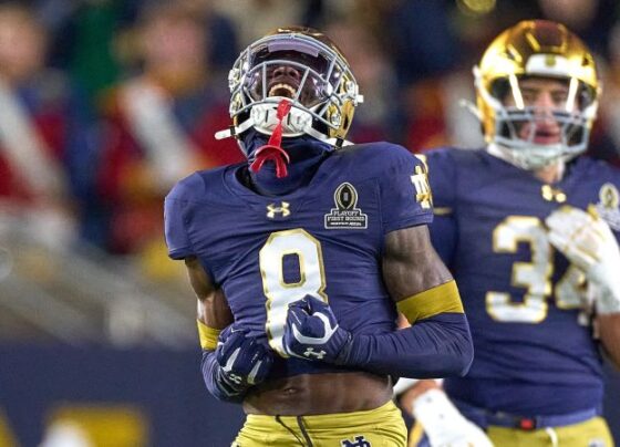 Notre Dame Fighting Irish running back Jeremiyah Love jumps over Indiana Hoosiers defensive back Amare Ferrell.