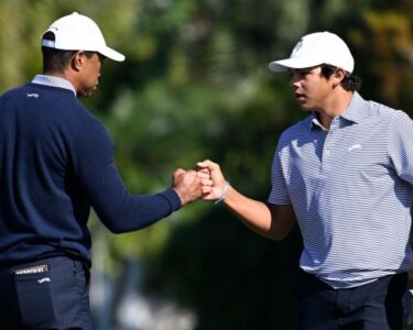 Tiger Woods and son Charlie Woods warm up on Friday ahead of the PNC Championship.