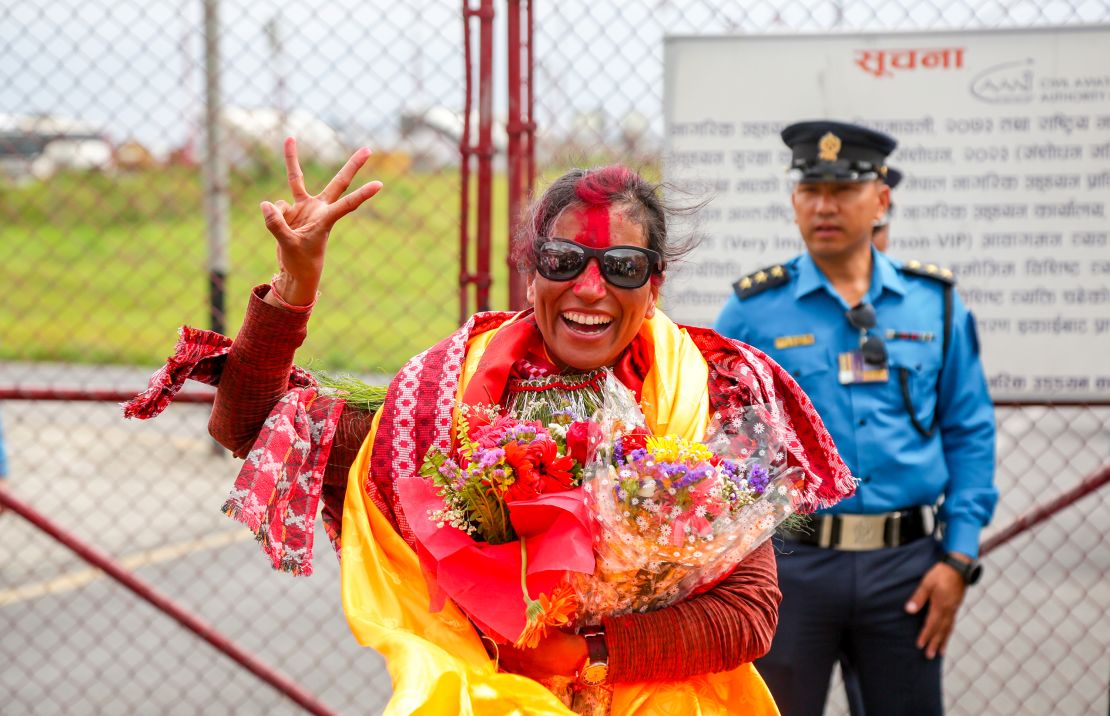 KATHMANDU, NEPAL - MAY 27: Purnima Shrestha a Mountaineer and a photojournalist poses for a photo as she is welcomed by her friends and family members upon her arrival at the airport after setting a record of climbing Mt. Everest three times in this single season in Kathmandu, Nepal on May 27, 2024. She is also the first woman to climb the peak of Dhaulagiri, the seventh highest mountain in the world. (Photo by Sunil Pradhan/Anadolu via Getty Images)