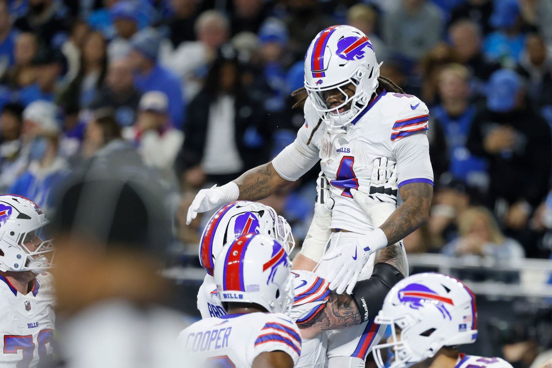 Cook celebrates with teammates after scoring against the Detroit Lions on December 15.