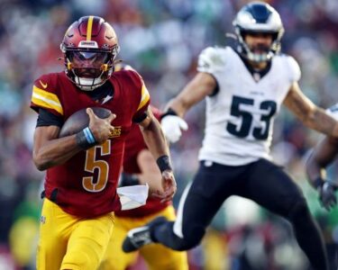 LANDOVER, MD - DECEMBER 22: Philadelphia Eagles quarterback Jalen Hurts (1) is knocked out of the game on a tackle by Washington Commanders linebacker Bobby Wagner, top and Commanders linebacker Frankie Luvu at the Northwest Stadium in Landover, MD on December 22, 2024. (Photo by John McDonnell/ for The Washington Post via Getty Images)