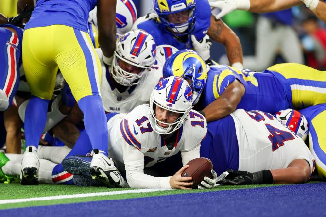 Buffalo Bills quarterback Josh Allen scores a touchdown during his team's 44-42 loss to the Los Angeles Rams at SoFi Stadium in Inglewood, California, on Sunday, December 8. Allen became the first NFL quarterback to score three passing touchdowns and three rushing touchdowns in a single game.