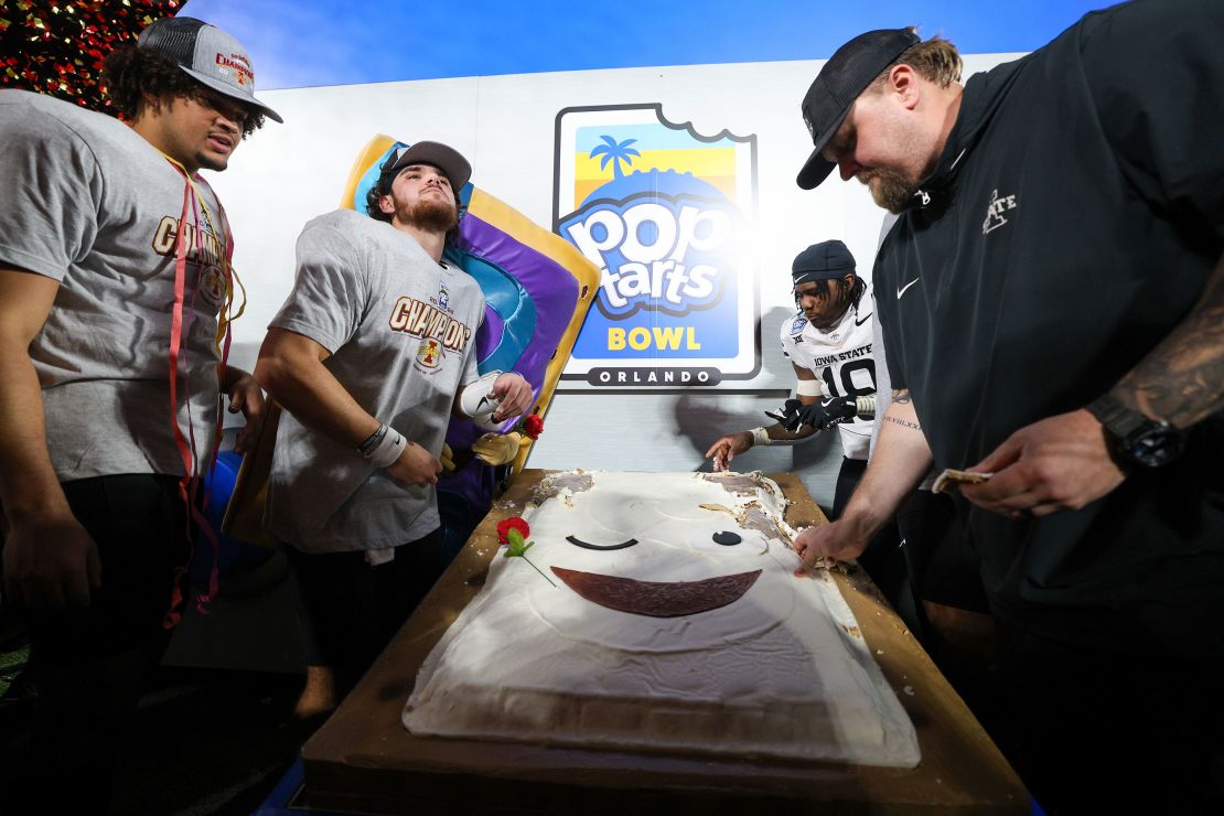 Iowa State players and coaches feast on a cinnamon roll Pop-Tart following the win.