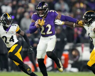 Baltimore Ravens quarterback Lamar Jackson runs with the ball against the Pittsburgh Steelers during the first half of an NFL wild-card playoff football game.