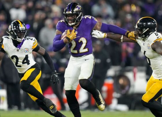 Baltimore Ravens quarterback Lamar Jackson runs with the ball against the Pittsburgh Steelers during the first half of an NFL wild-card playoff football game.