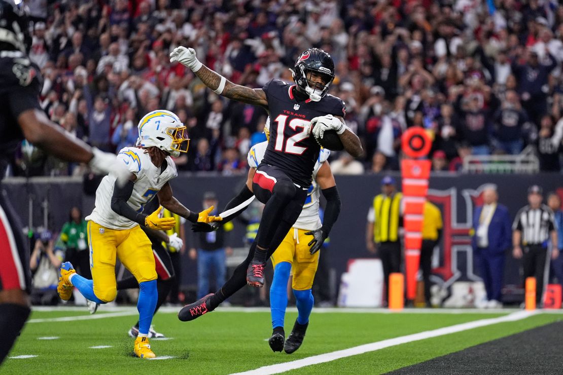 Houston Texans wide receiver Nico Collins (12) leaps into the end zone for a touchdown.