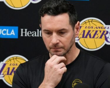 Redick and Reaves embrace during a Lakers practice session.