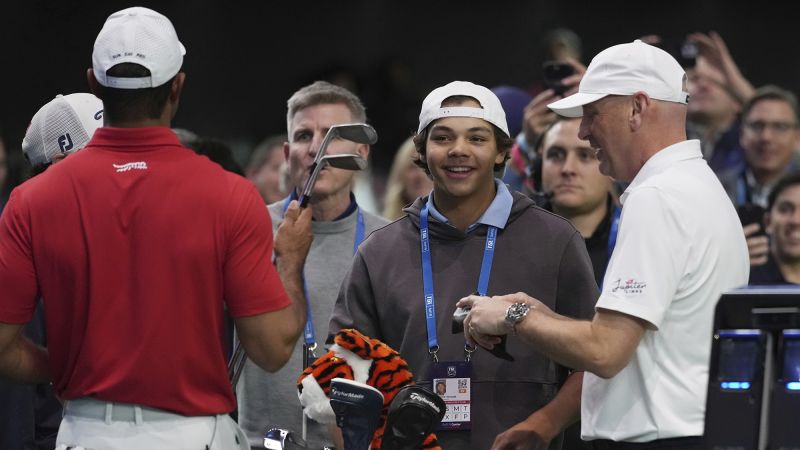 Tiger Woods’ son Charlie chuckles while watching his dad suffer heavy defeat in TGL debut | CNN