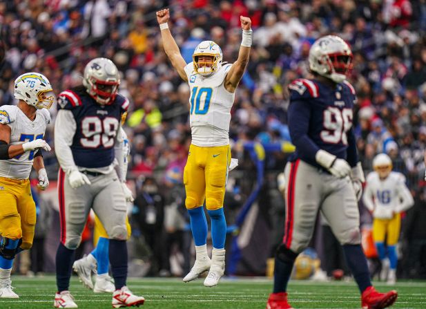 Los Angeles Chargers quarterback Justin Herbert celebrates after throwing a touchdown pass in Foxborough, Massachusetts, on Saturday, December 28. With his 281-yard outing, Herbert eclipsed Peyton Manning’s record for most passing yards in the first five years of a career. The Chargers beat the New England Patriots 40-7.