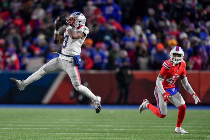 New England Patriots wide receiver DeMario Douglas, left, catches a pass in front of Buffalo Bills cornerback Christian Benford in Orchard Park, New York, on December 22. The Bills won 24-21.