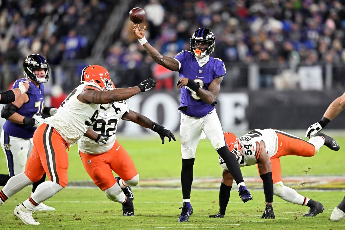 Lamar Jackson #8 of the Baltimore Ravens throws a pass ahead of Ogbo Okoronkwo of the Cleveland Browns during the second quarter at M&T Bank Stadium.