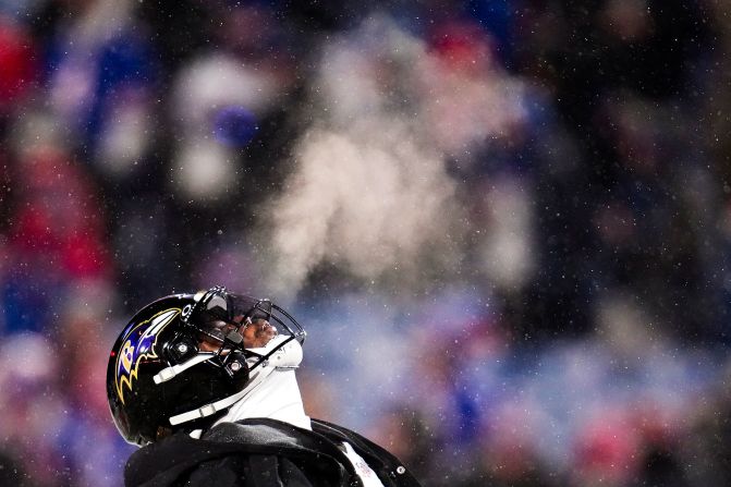 Baltimore Ravens quarterback Lamar Jackson warms up before playing against the Buffalo Bills in Orchard Park, New York, on January 19. The temperature was below 20 degrees at kickoff.