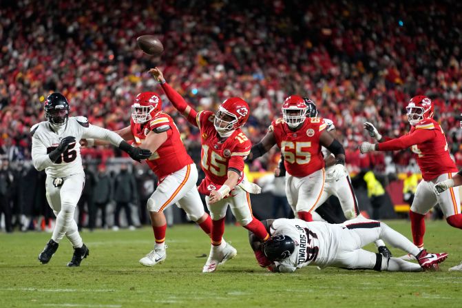 Kansas City Chiefs quarterback Patrick Mahomes throws a touchdown pass to tight end Travis Kelce under pressure from Houston Texans defensive tackle Mario Edwards Jr. during the second half of an AFC divisional playoff game in Kansas City, Missouri, on Saturday, January 18. The Chiefs won 23-14 and advanced to their 7th straight AFC Championship.