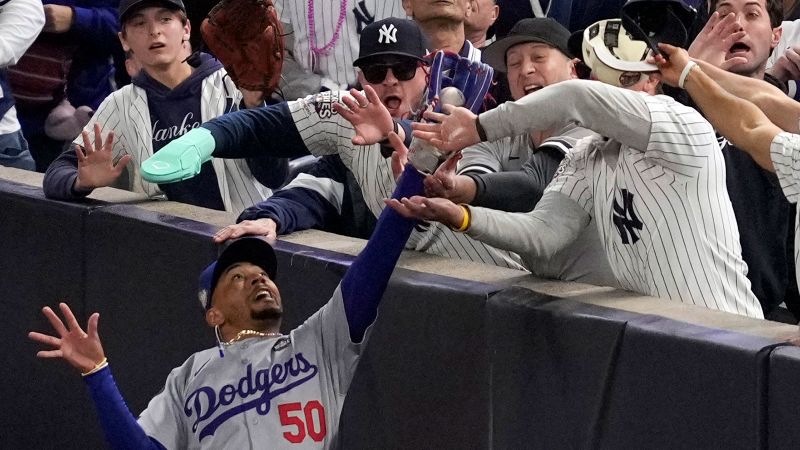 Yankees fans who interfered with Mookie Betts during World Series banned from all MLB games | CNN