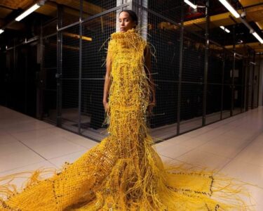 'Somewhat robot, somewhat human': designer used 12,000ft fiber optic cable to weave a striking 50lb dress that will turn heads - and no, you can't buy it