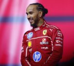 Hamilton walks out on stage with the new Ferrari car, alongside team principal Frédéric Vasseur and driver Charles Leclerc.