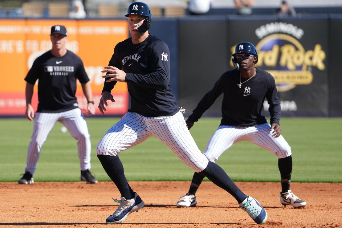 Feb 17, 2025; Tampa, FL, USA; New York Yankees outfielder Aaron Judge (99) (center) and third base Jazz Chisholm Jr. (13) (right) participate in a base running drill during spring training practice at George M. Steinbrenner Field. Mandatory Credit: Dave Nelson-Imagn Images