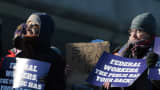 Protesters demonstrate in support of federal workers outside of the U.S. Department of Health and Human Services on Feb. 14, 2025 in Washington, DC.