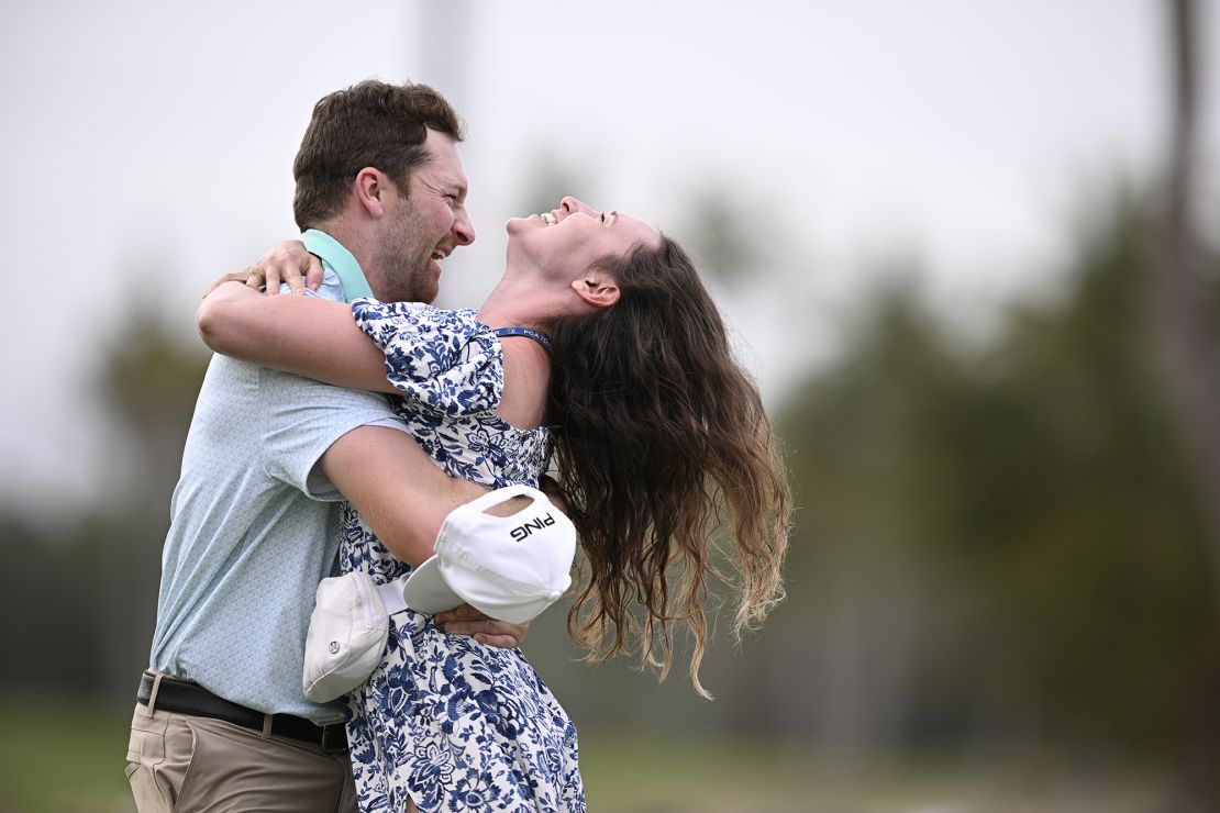 Campbell and girlfriend Kelsi McKee embrace on the 18th green at the Mexico Open.