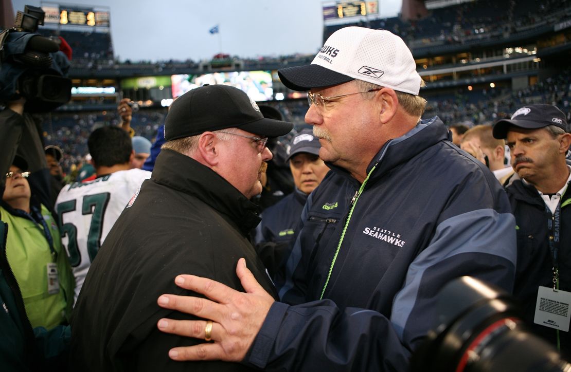 Holmgren (right) hired Reid (left) to his Packers staff.