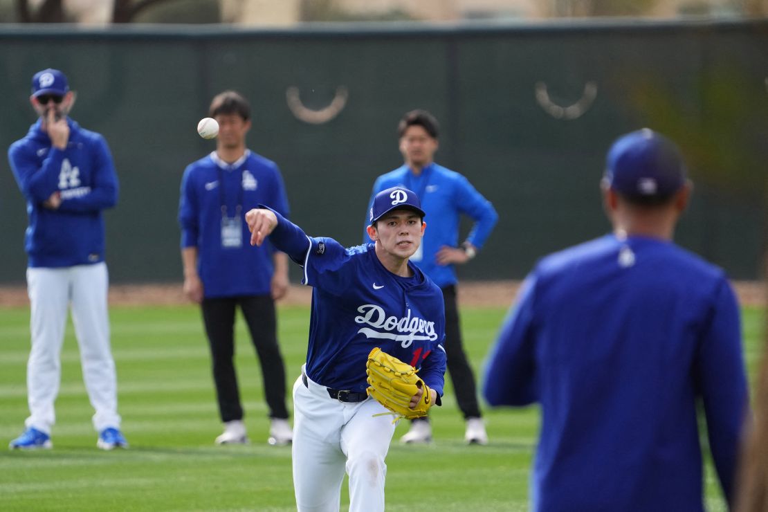 Feb 13, 2025; Glendale, AZ, USA; Los Angeles Dodgers Roki Sasaki throws during a Spring Training workout at Camelback Ranch Mandatory Credit: Joe Camporeale-Imagn Images